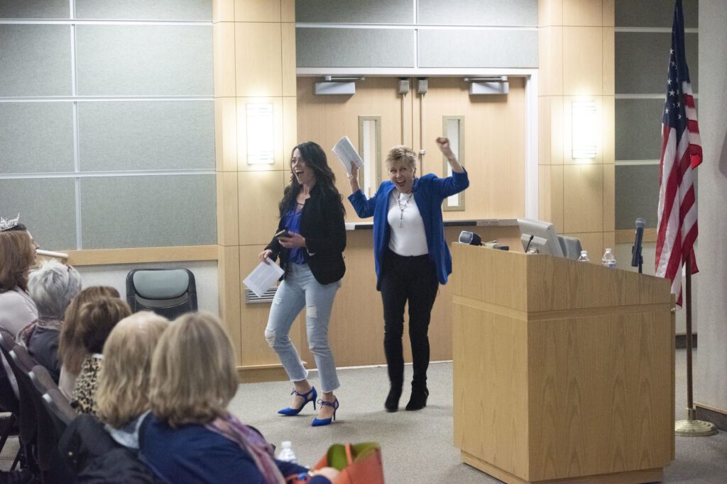 kristin and mary fran walking into auditorium laughing